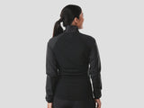 Trek Circuit Women's lightweight wind-resistant cycling jacket, packable windshell, shown in a natural outdoor setting.