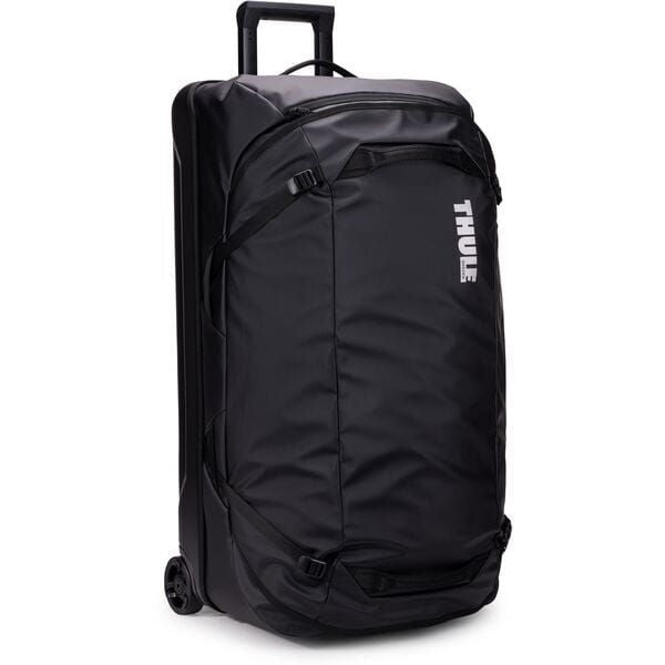 Black Thule Chasm rolling duffel bag with durable, weather-resistant fabric and sturdy wheels for travel accessories.