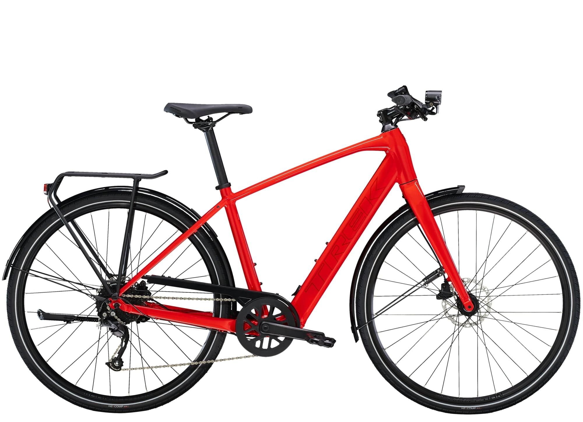 Trek FX+ 2 e-hybrid bike with hybrid frame, front lights, mudguards, rear rack, and pedal assist system in a city setting