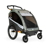 Burley D'Lite X double bike trailer and stroller with adjustable suspension, shown with safety harness and durable frame.