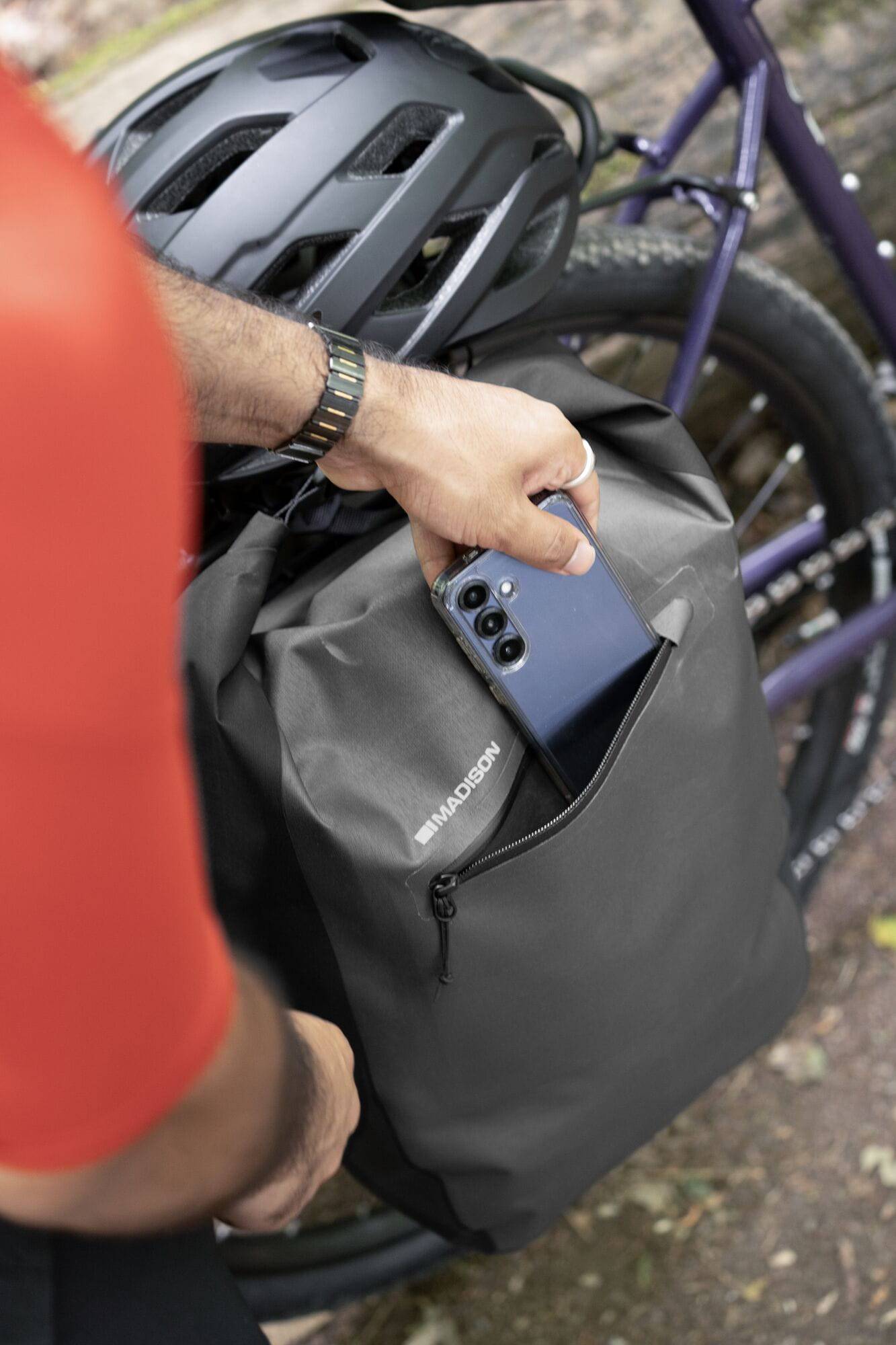 Madison Bags Roam 30L waterproof pannier bag with quick-release mounting system, shown attached to a bicycle rack.