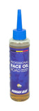Morgan Blue Race Oil road bike lubricant in a workshop setting, showcasing the friction-reducing bike oil for optimal performance.