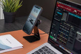 Quad Lock Desk Mount V2 with adjustable arm and nano suction base holding a smartphone for hands-free use.