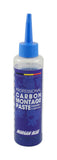 Morgan Blue Carbon Assembly Paste tub for lubricating carbon and aluminium bike parts, shown in a workshop setting.