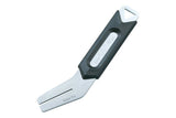 Topeak RotorTru bike brake rotor truing tool in black and silver for precise rotor alignment, shown in a workshop setting.