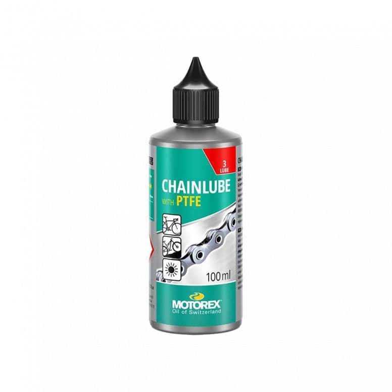 Motorex Chainlube with PTFE 100ml for synthetic bike chains, ideal for dry conditions, shown in workshop setting.