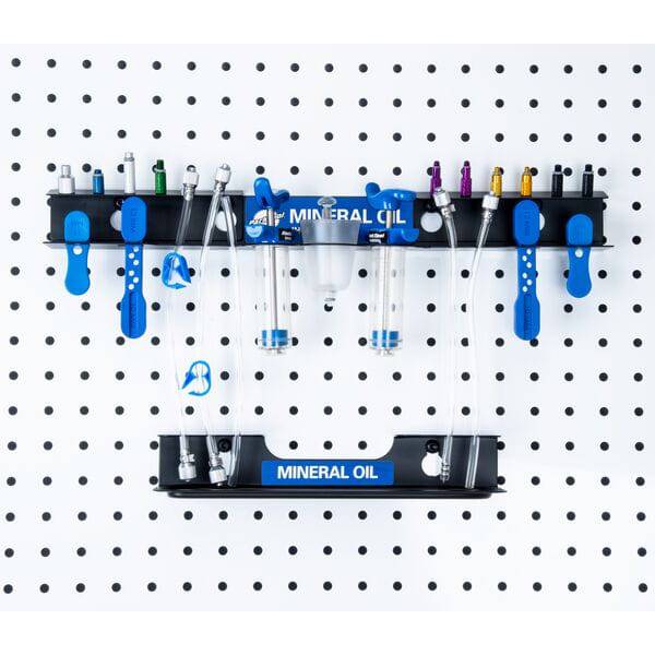 Park Tool JH-4 wall-mounted bleed kit organizer for hydraulic brake accessories, stored on a workshop wall.