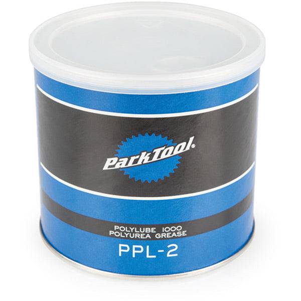 Park Tool PPL-2 Polylube 1000 bicycle grease for carbon and all components, shown in a workshop setting with grease tube visible.