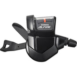 Shimano Alfine S700 11-speed MTB shift lever with optical gear display and cables, mounted on a bicycle handlebar.
