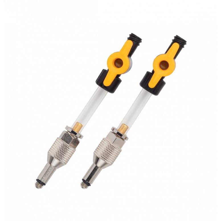 Jagwire Elite DOT bleed kit replacement parts with universal adapters for 1/4 turn valves, shown with workshop tools and components