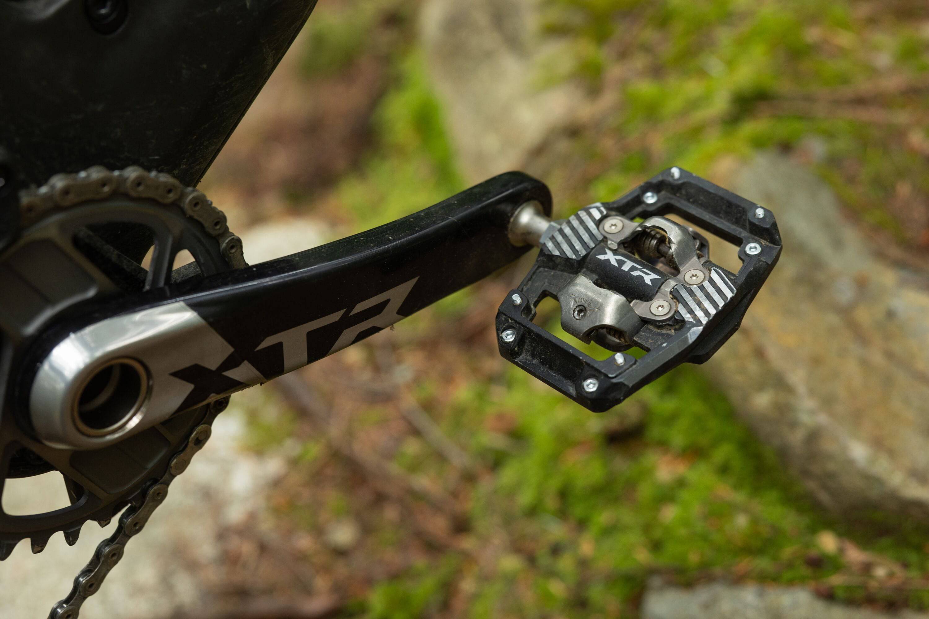 Shimano XTR PD-M9220 trail wide platform mountain biking pedals with durable metal construction and textured grip surface.