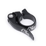 Black KUK quick release seat clamp for 28.6mm Kinesis seat posts, made by Upgrade, shown on a bicycle component.