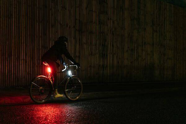 Knog Lil' Cobber bike light showing its compact design, USB port, waterproof casing, and bright 330° visibility.