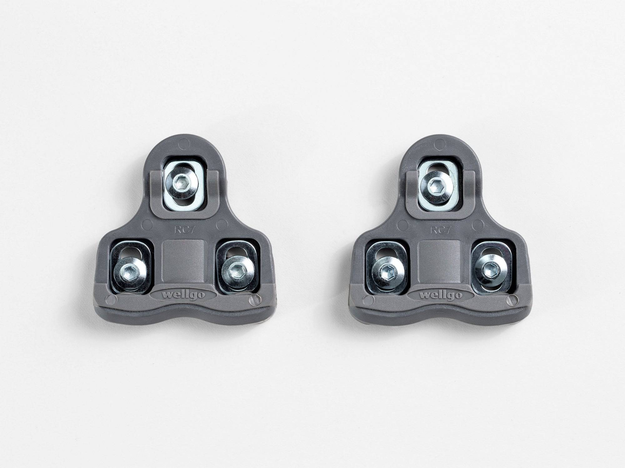 Bontrager Road clipless pedal cleat set in grey with mounting hardware, designed for road cycling shoes and clipless pedals.