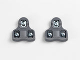 Bontrager Road clipless pedal cleat set in grey with mounting hardware, designed for road cycling shoes and clipless pedals.