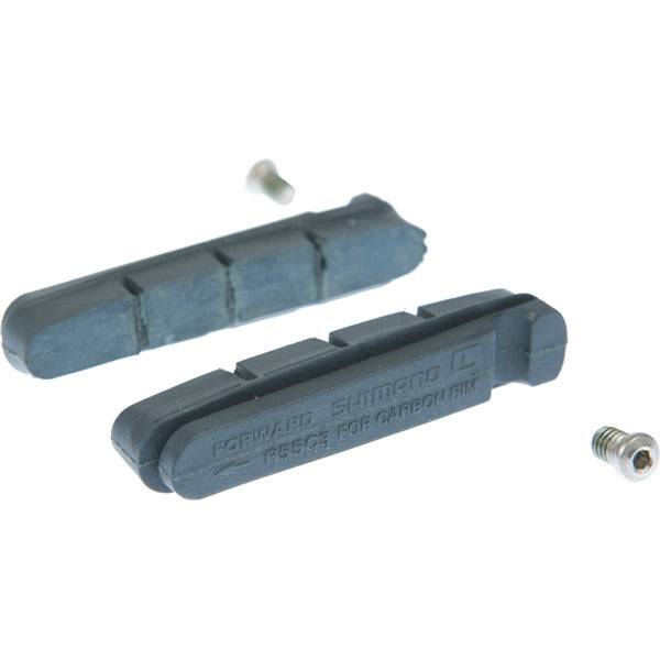 Shimano R55C3 carbon rim brake pads for Dura-Ace road brake systems, showing close-up of brake pad design and mounting hardware.