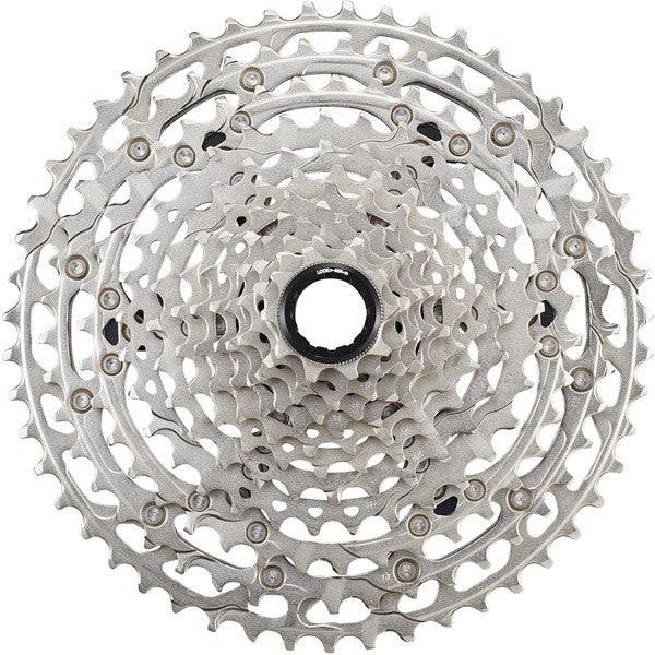 Shimano Deore Deore CS-M6100 12-speed MTB cassette with 10-51T gears and Hyperglide technology, shown on a bike drivetrain.