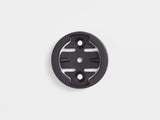 Black Bontrager Pro Blendr Garmin Adapter Puck for Blendr stem mounts, designed for easy Garmin device attachment.