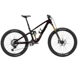 Trek Fuel MX 9.8 XT Gen 7 mountain bike with adjustable suspension, black frame and knobby tires for versatile trail riding.