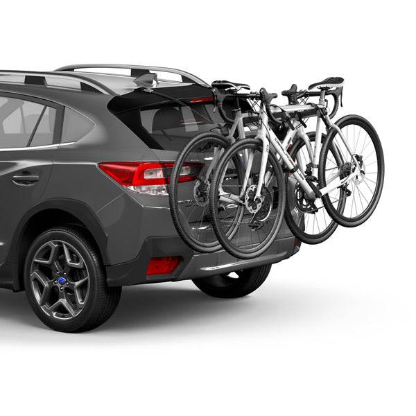 Thule OutWay rear-mount 2 bike carrier rack with anti-sway and locking cable, showing mounted bikes and secure locking features