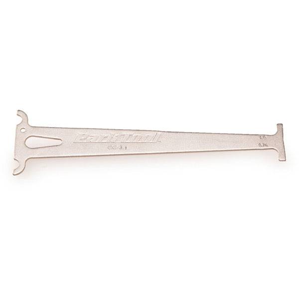 Park Tool CC-3.2 chain wear indicator gauge measuring 10-speed bike chains in a workshop setting.