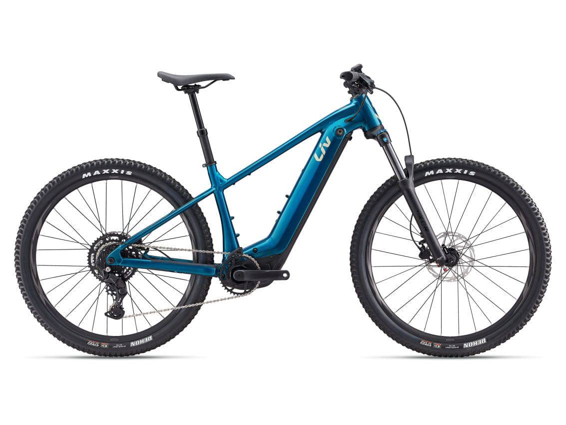 Liv Lurra E+ 2 electric mountain bike with integrated battery and SyncDrive motor, shown in a scenic outdoor setting