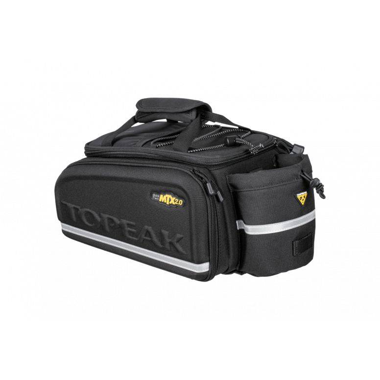 Topeak MTX TrunkBag EXP bike rack bag in black with quick-release system and expandable storage, mounted on a bicycle.