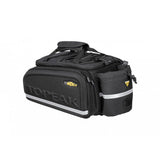 Topeak MTX TrunkBag EXP bike rack bag in black with quick-release system and expandable storage, mounted on a bicycle.