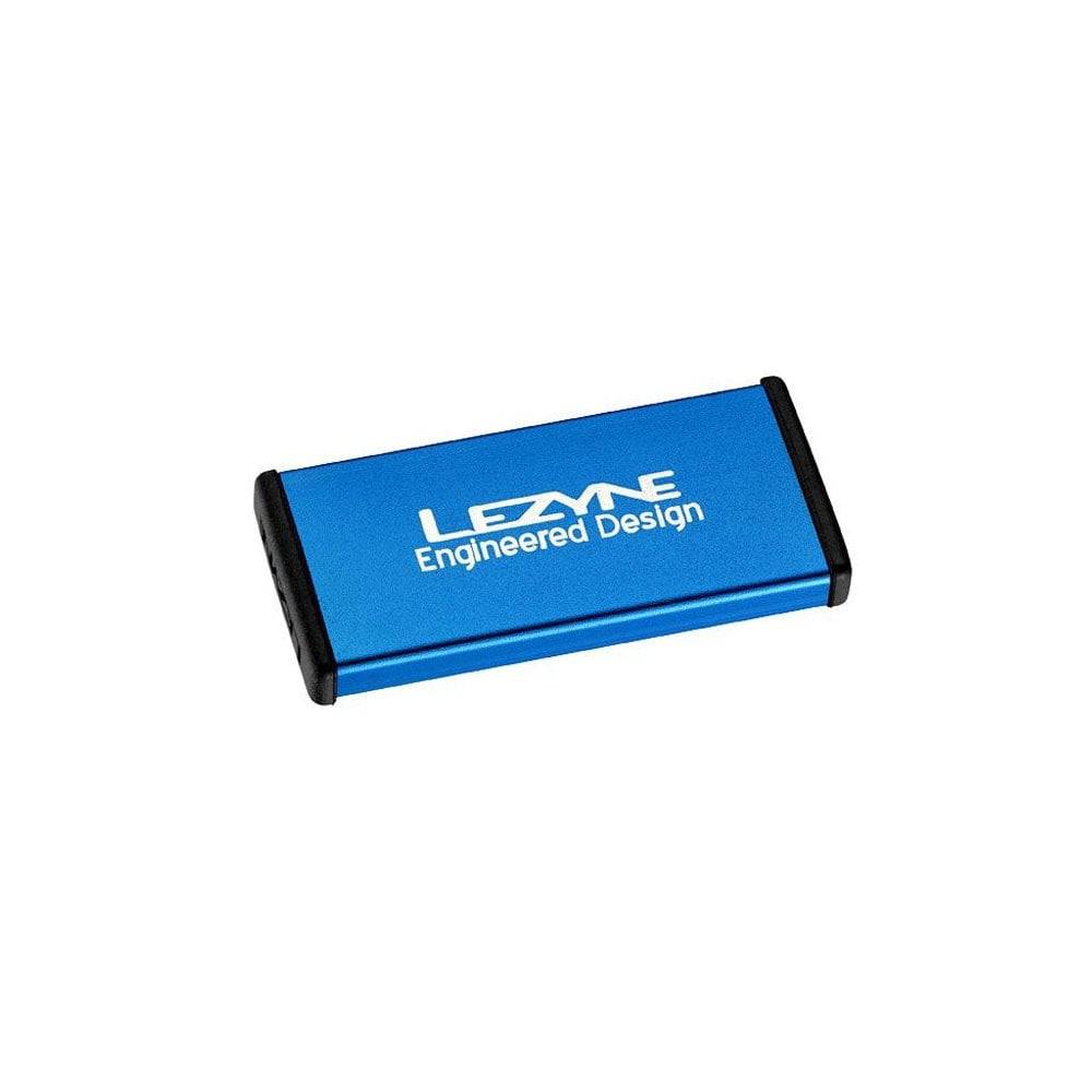 Lezyne Metal Patch Kit with waterproof aluminium case for quick tyre repairs, shown in a workshop setting.