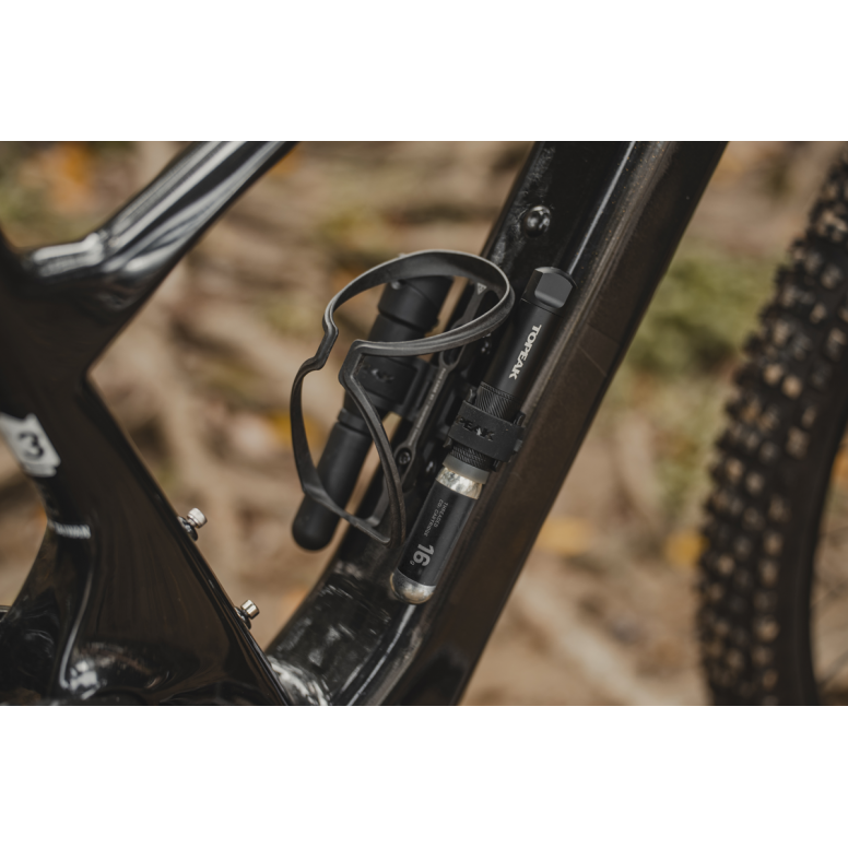 Topeak Cage Mount Side accessory for bottle cage accessories on e-bikes and mountain bikes, shown mounted on bike frame.