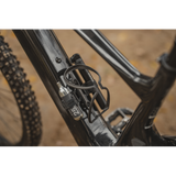 Topeak Cage Mount Side accessory for bottle cage accessories on e-bikes and mountain bikes, shown attached to bike frame.