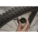 Topeak Shuttle Gauge Digital 2.0 tire pressure gauge showing pressure reading, compatible with Presta and Schrader valves.