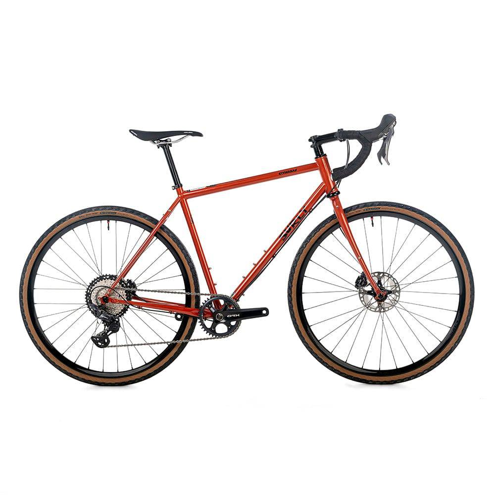 Surly Straggler V2 gravel bike with Shimano GRX 12-speed gears and thru-axle wheels, shown on a shaggy carpet.