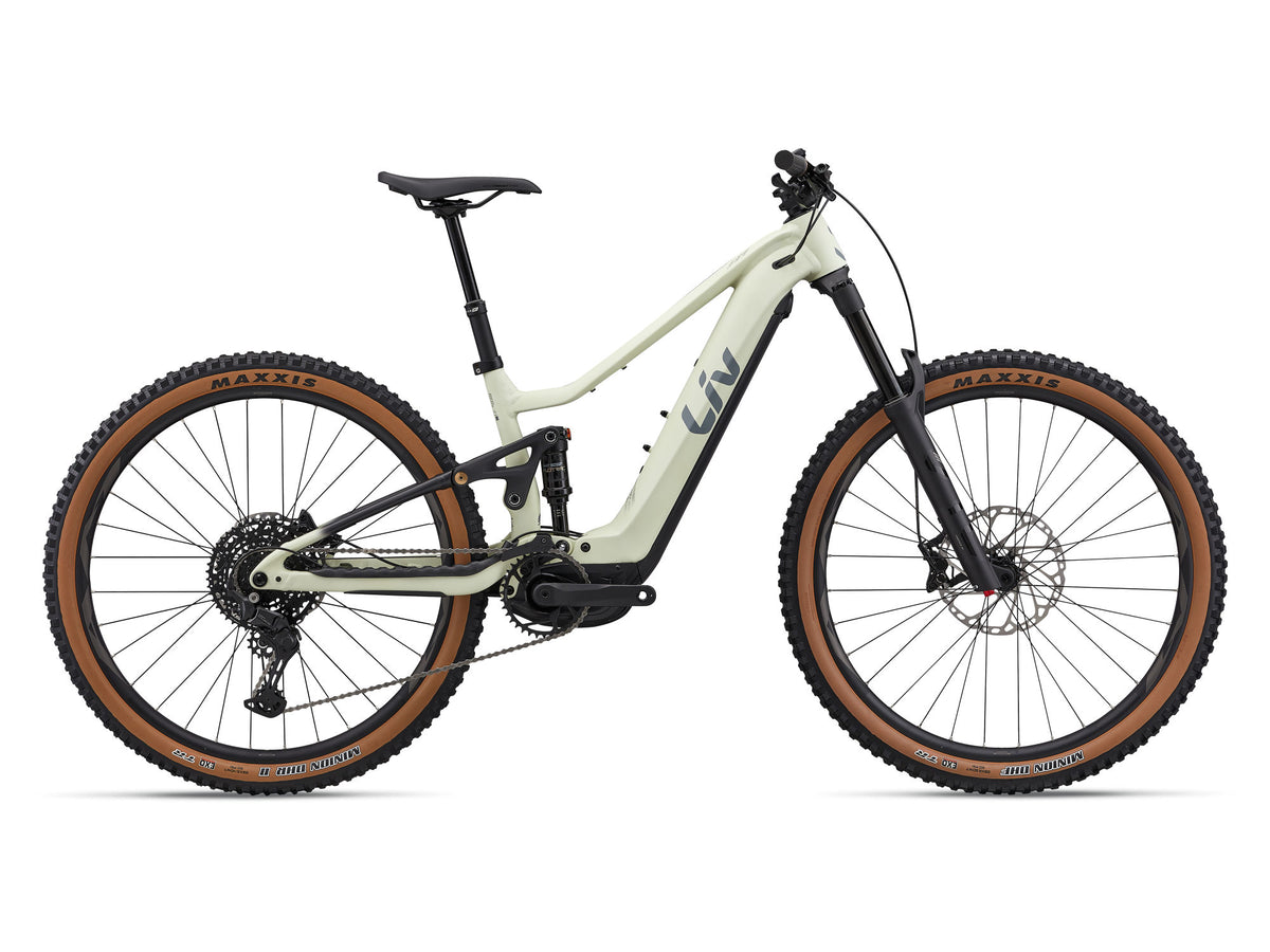 Liv Embolden E+ 1 2026 full-suspension electric mountain bike with SyncDrive Pro motor, shown in a rugged outdoor setting.