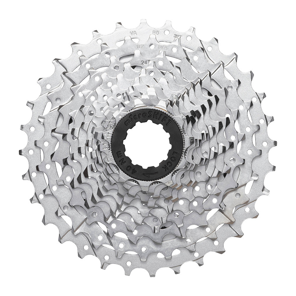 MicroSHIFT H-Series 11-speed road bike cassette with 11-34T steel chrome-plated gears, shown mounted on a bike drivetrain.