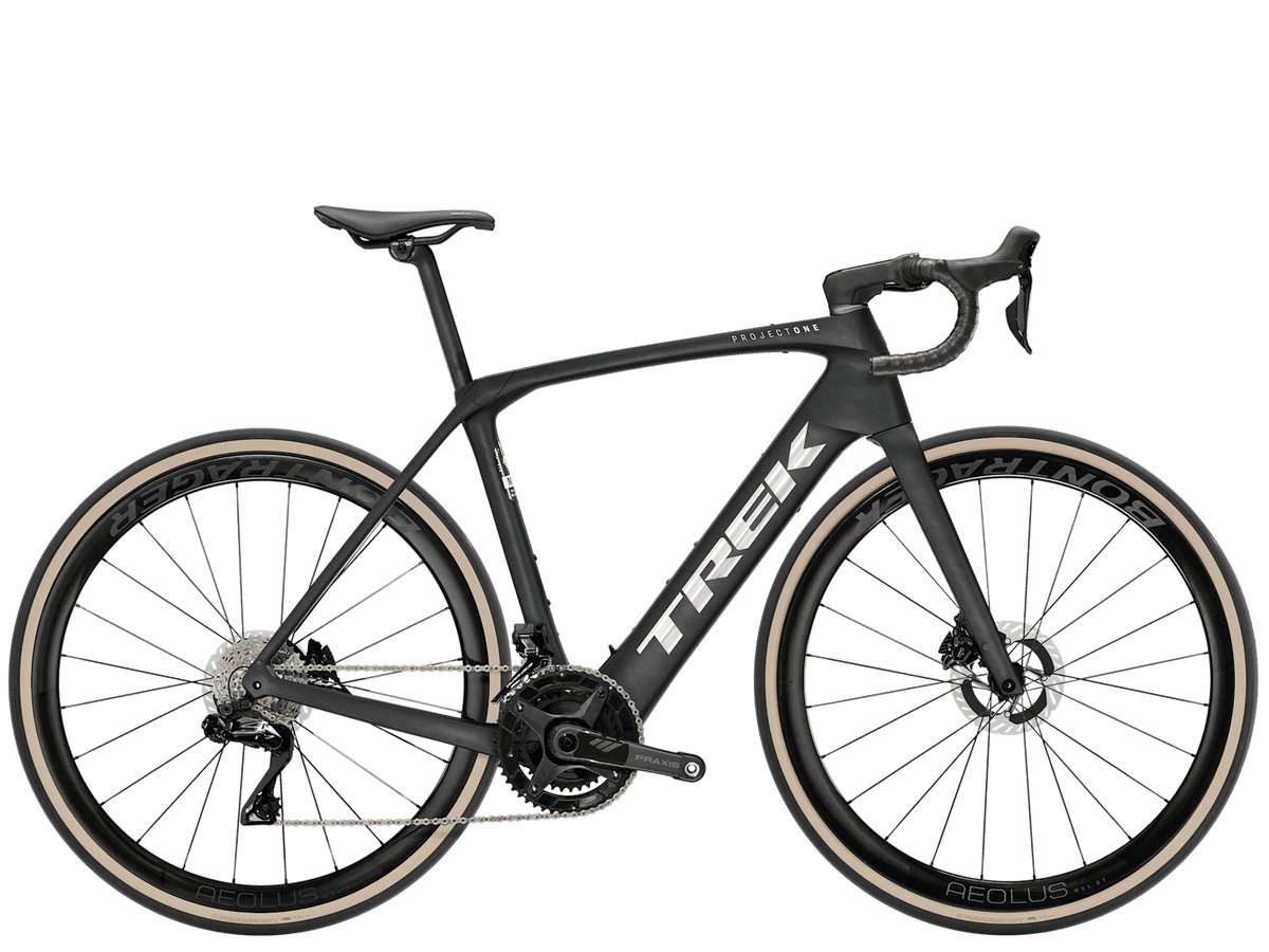 Trek Domane+ SLR 9 electric road bike with carbon frame, quiet TQ Harmonic Pin Ring motor, and extended range battery.
