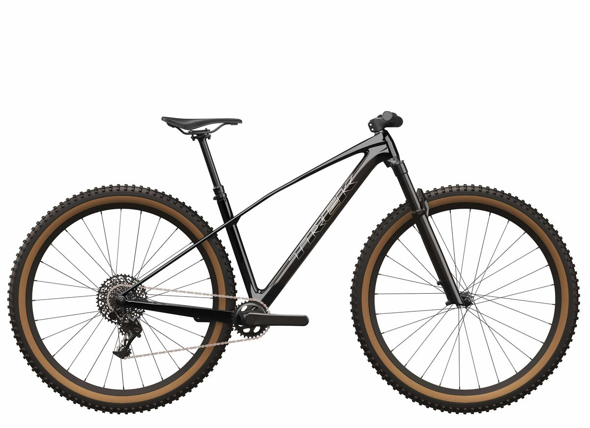 Trek Procaliber 9.6 Gen 3 mountain bike with IsoBow frame for trail riding, featuring a sleek black frame and rugged tires.