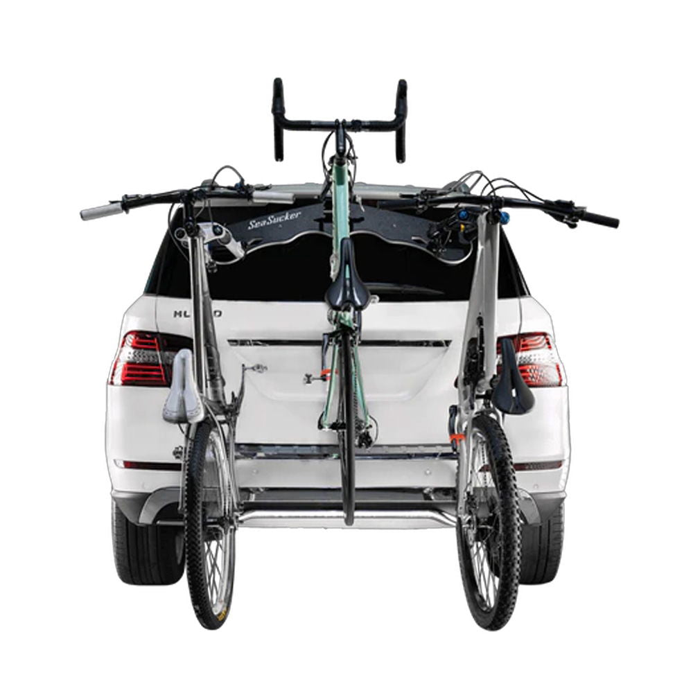 SeaSucker Bomber 3 Bike Rack with HUSKE Fork Mount vacuum system mounted on a car carrying three bikes.