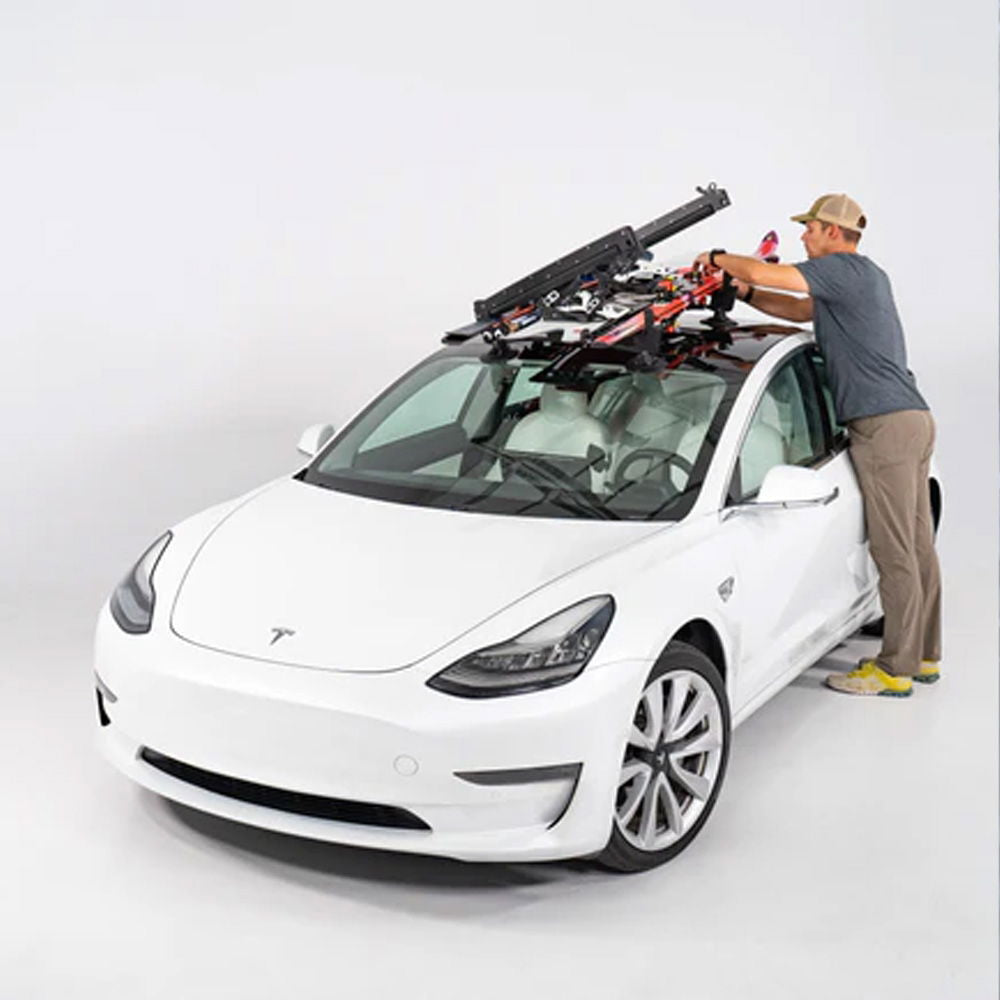 SeaSucker Classic Ski Rack vacuum mount holding four sets of skis and snowboards, mounted on a vehicle for outdoor winter sports.