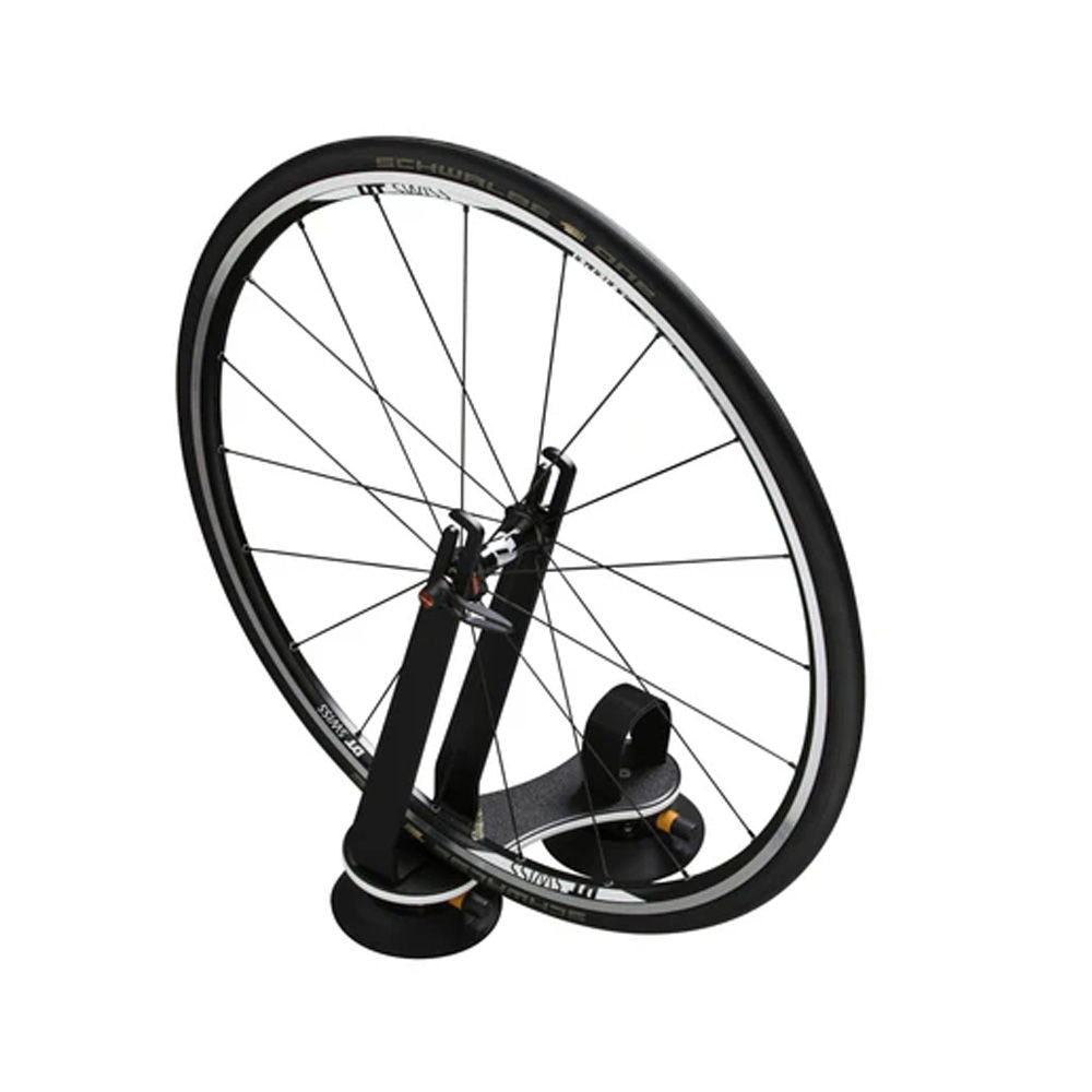 SeaSucker Flight Deck bike rack accessory with front wheel mounting and stability features, shown with mounted wheel on a black platform.