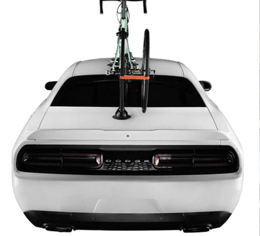 SeaSucker Hogg front wheel holder for quick-release hubs, bike rack accessory with strap securing bike wheel.