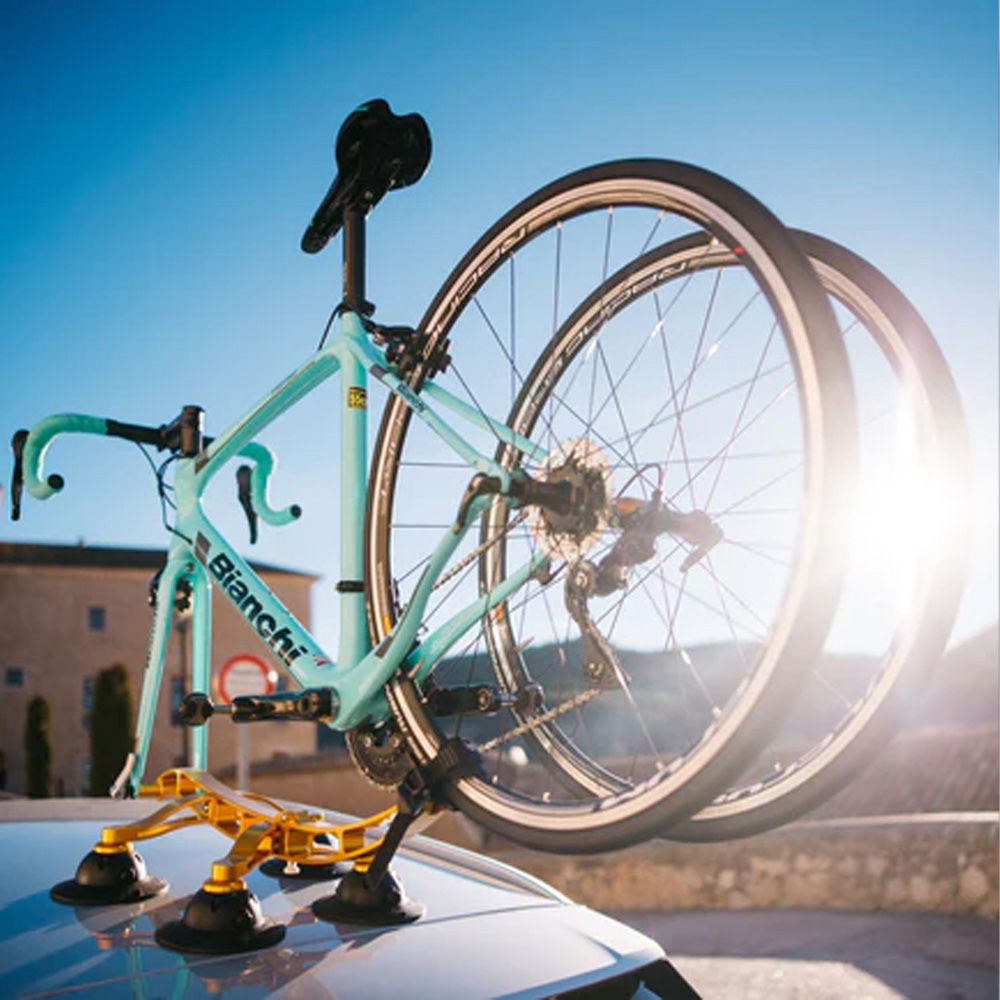 SeaSucker Komodo 1 Bike Rack for sports cars and convertibles, mounted on a compact roof with bikes ready for transport.