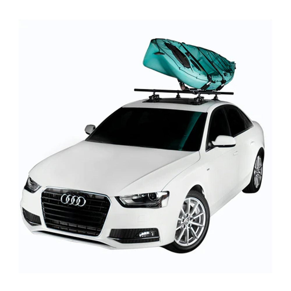 SeaSucker Monkey Bars 60-inch roof cross-bar system attached to a vehicle roof for outdoor gear transport, with gear loaded on top.