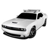 SeaSucker Monkey Bars 48-inch adjustable roof cross-bar system attached to car roof with sports gear mounted on top.