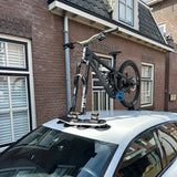 SeaSucker Bomber 3 bike rack with HUSKE fork mount vacuum system holding an e-bike on a vehicle rooftop.