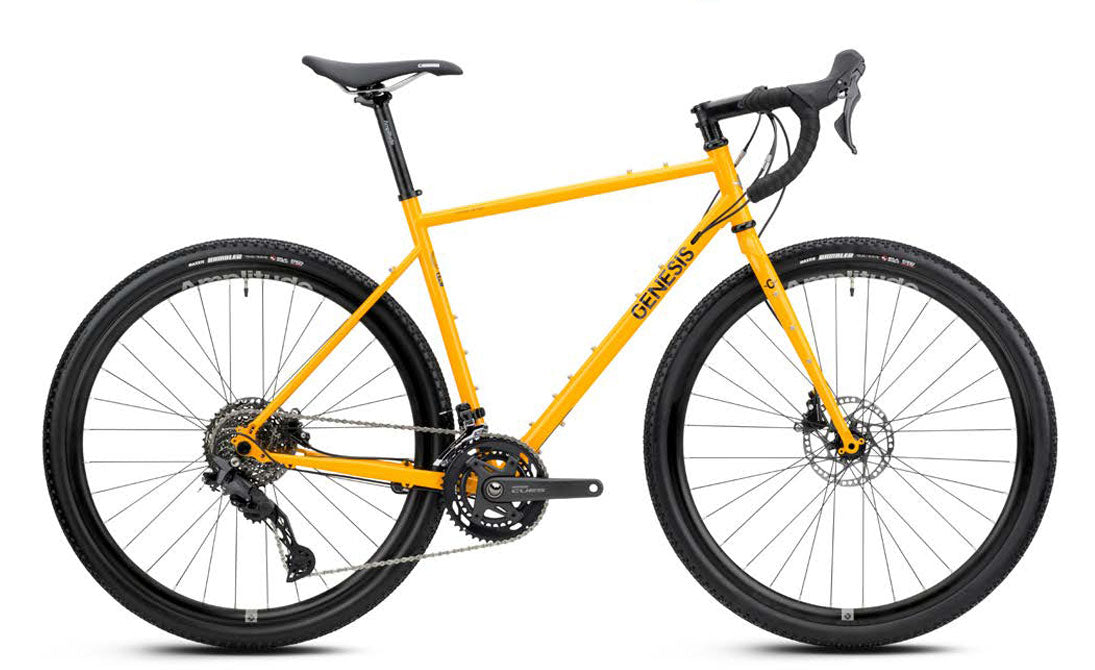 Genesis Croix de Fer 30 2026 gravel bike with Shimano 10-speed drivetrain and hydraulic brakes, shown with rugged tires and frame.