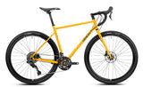 Genesis Croix de Fer 30 2026 gravel bike with Shimano 10-speed drivetrain and hydraulic brakes, shown with rugged tires and frame.