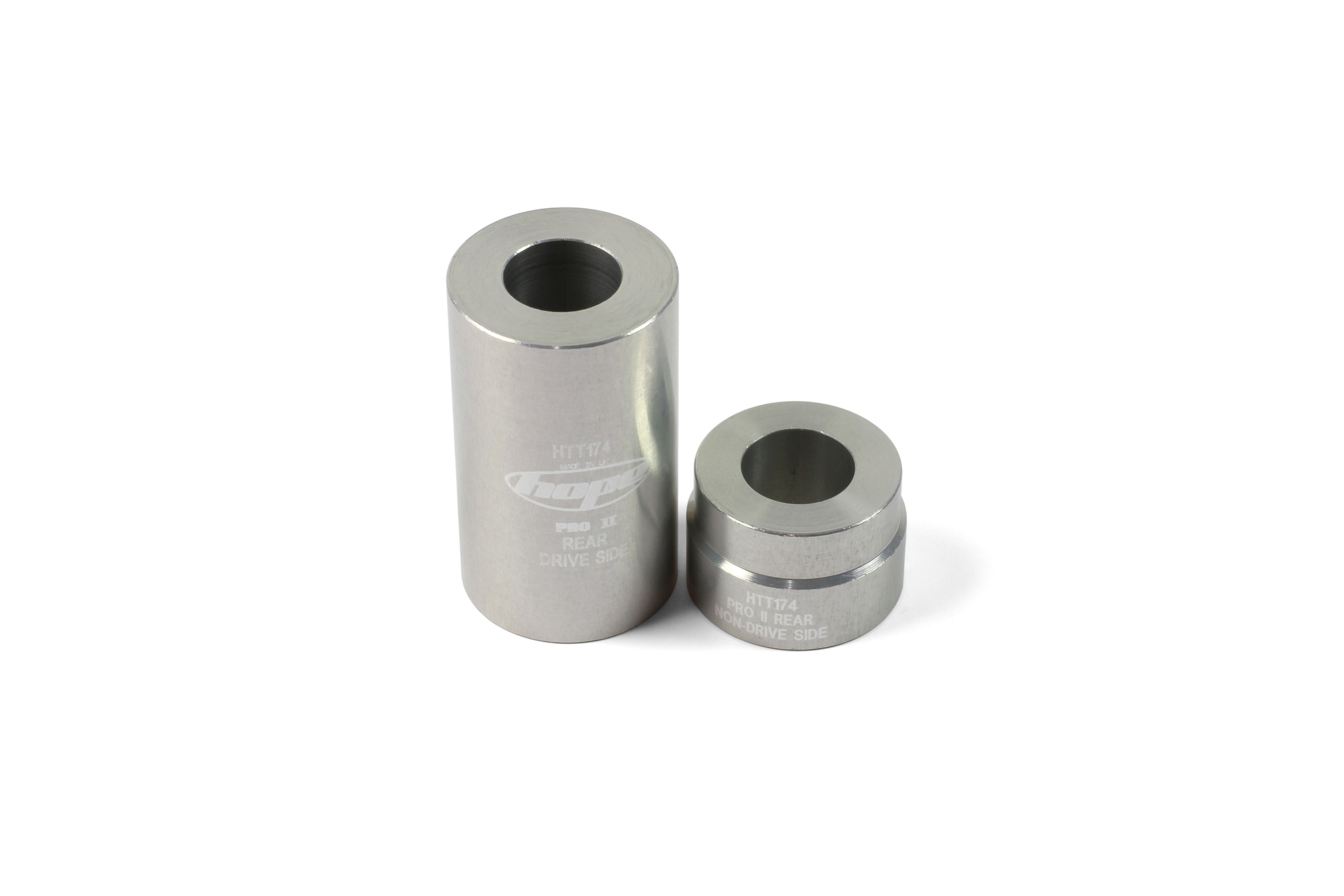 Hope Tool Bearing Support Bush pair for hub maintenance, showing metal bushings and workshop tools on a workbench.