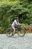 Madison Roam DWR women's cycling leggings with reflective inserts and zipped pocket, shown in a close-up view of the black leggings.