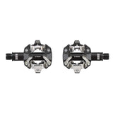 Look X-Track MTB pedals in dark grey, SPD-compatible off-road bike components with clipless pedal design and rugged surface.